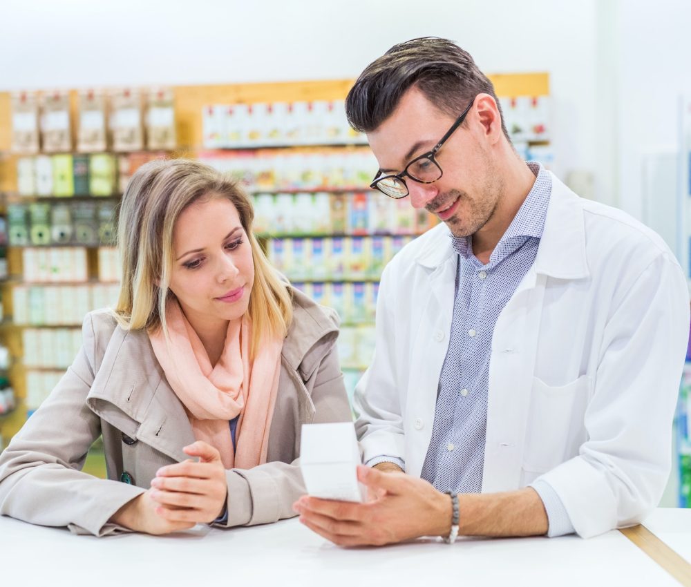 male-pharmacist-serving-a-female-customer-1-1