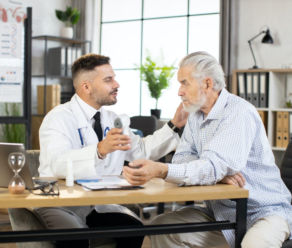 medical-worker-checking-temperature-of-senior-patient
