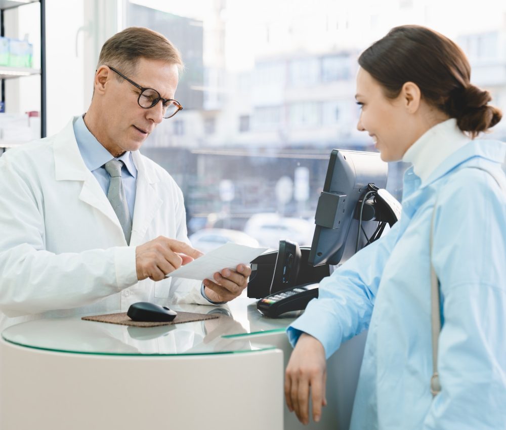 pharmacist-looking-at-medical-prescription-selling-drugs-medications-medicines-to-customer